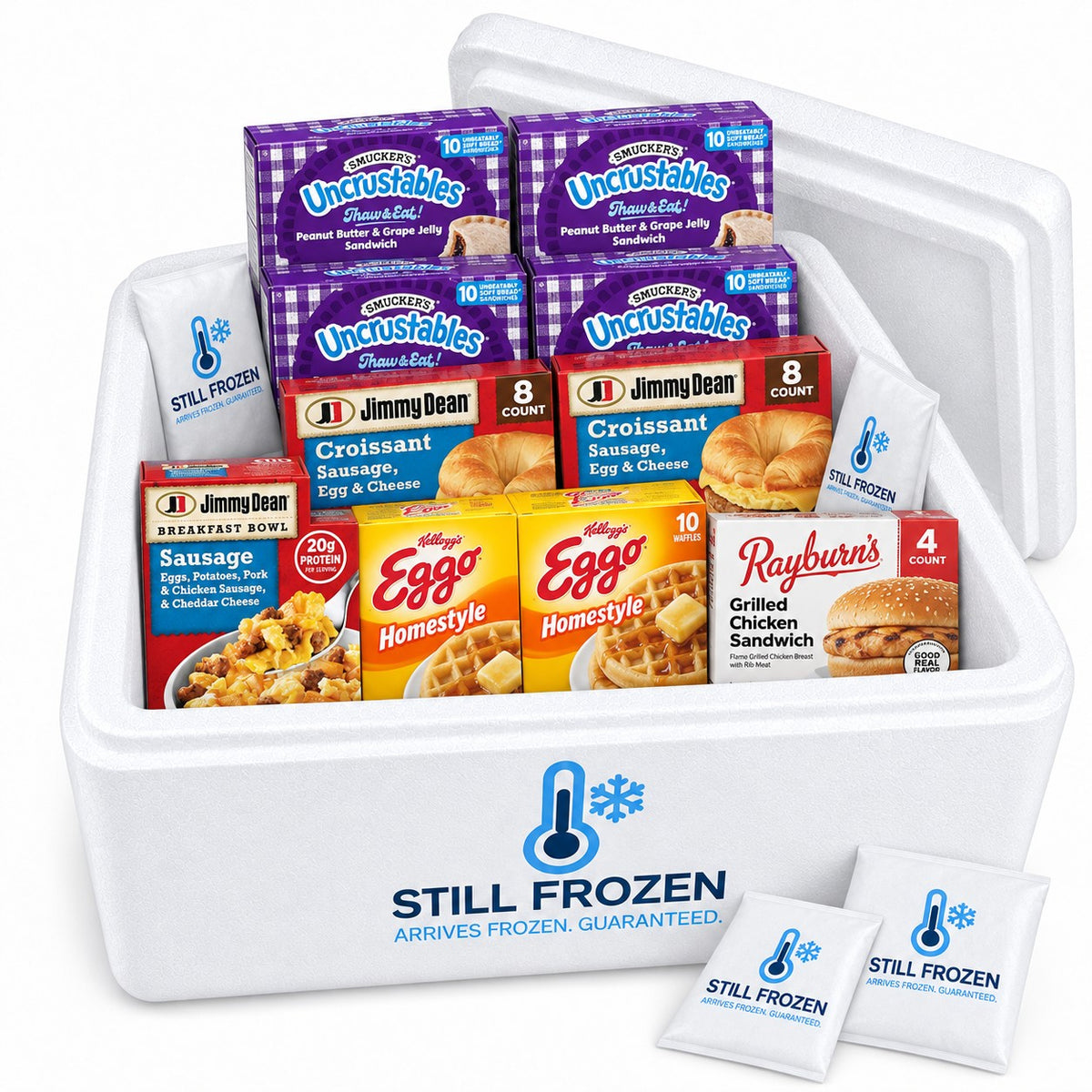 The Freezer Stock-Up in a Still Frozen foam cooler with gel packs: Uncrustables, Jimmy Dean croissants, Eggo waffles, Rayburn's chicken sandwiches, a Jimmy Dean breakfast bowl