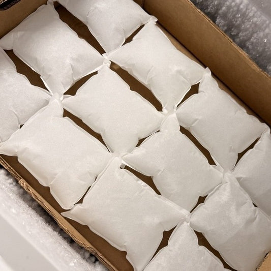 A full carton of our soft non-woven gel ice packs laid flat in the warehouse chest freezer